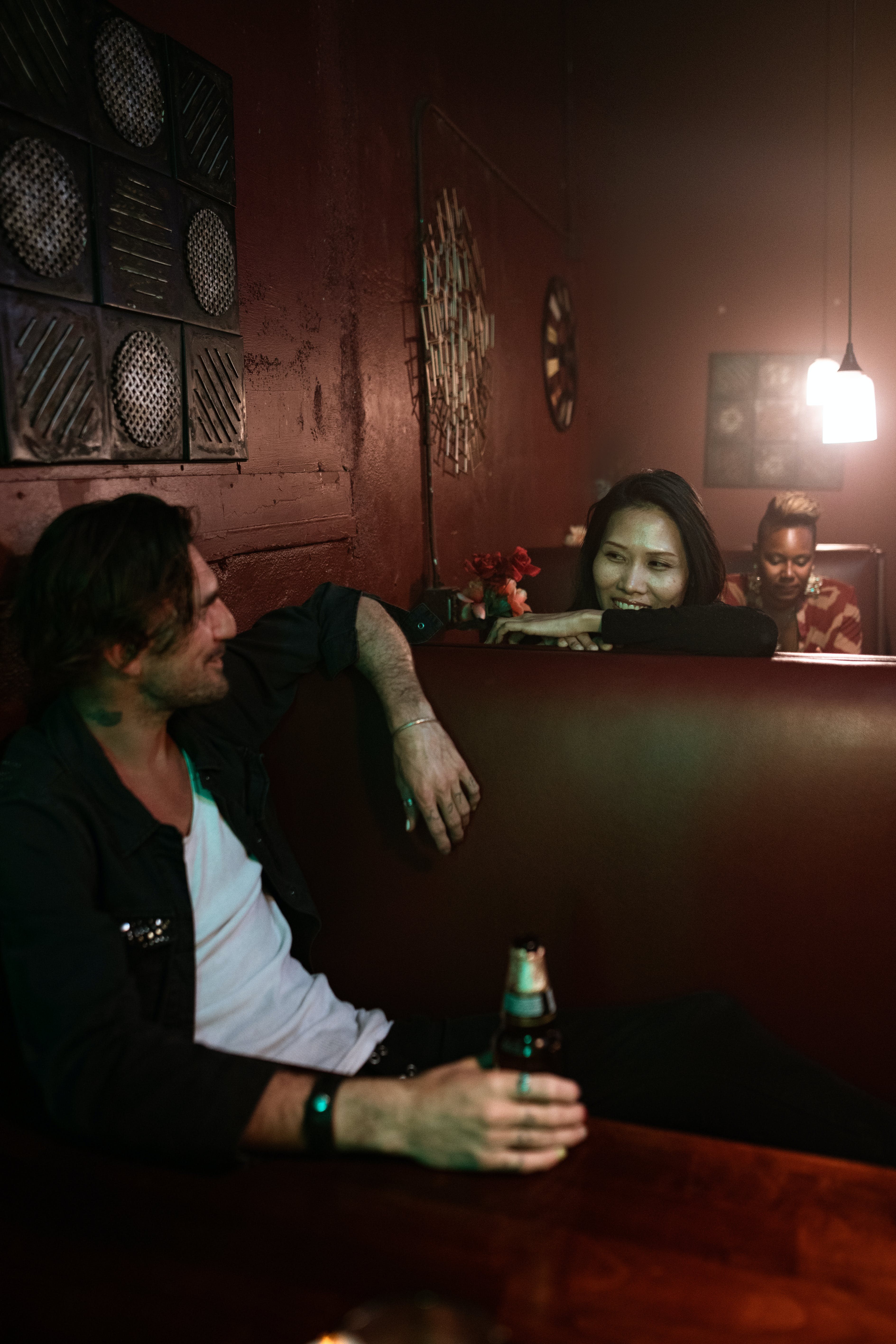 Two people chatting across the counter in a bar