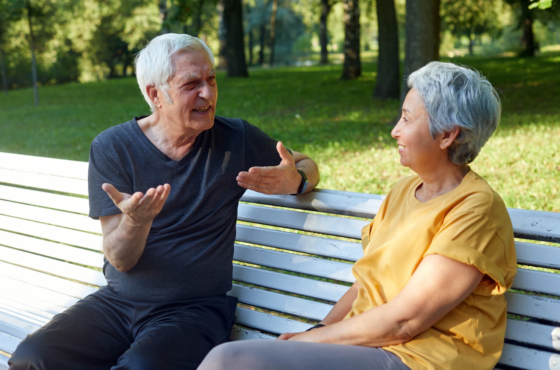 Two old friends catching up on a park bench
